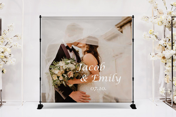 A wedding telescopic backdrop with the newlyweds' names, the event date, and their photo in the background.