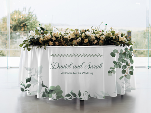A white wedding round tablecloth with the names of the newlyweds printed on it.