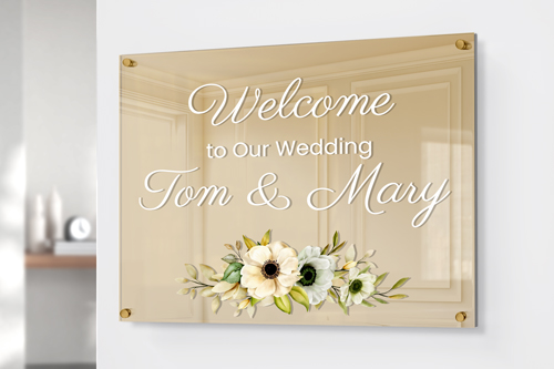 Gold plexiglass signs welcoming guests to a wedding.
