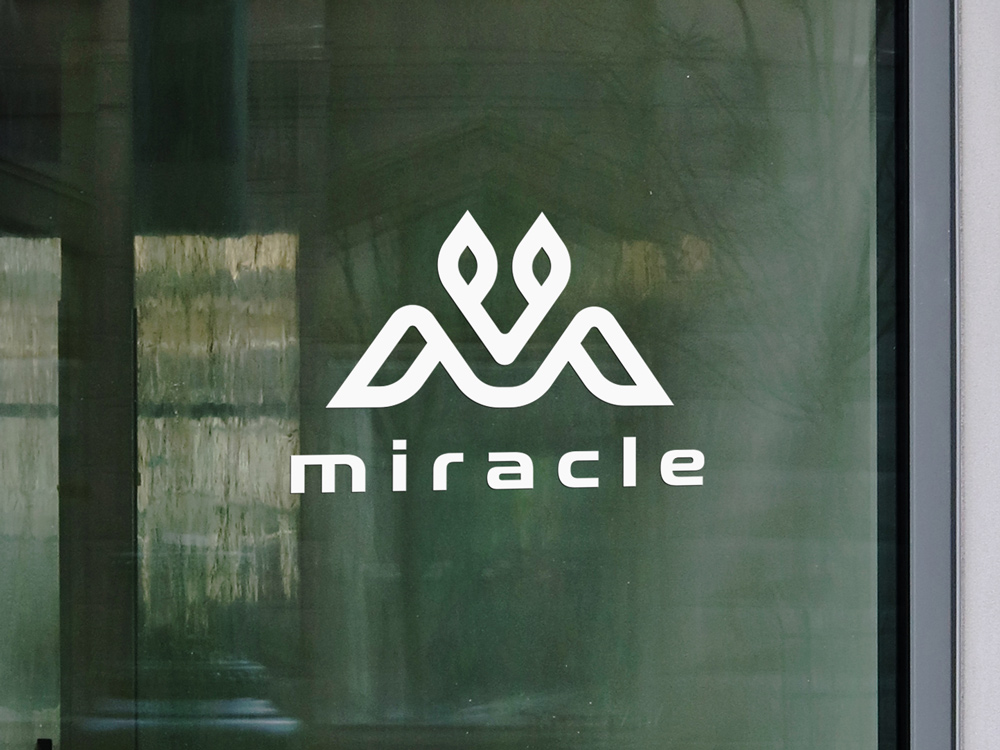 Vinyl white lettering applied on a window showcasing a brand's name and logo