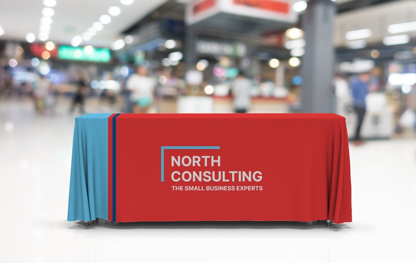 Red table cover for the small business experts reading North Consulting.
