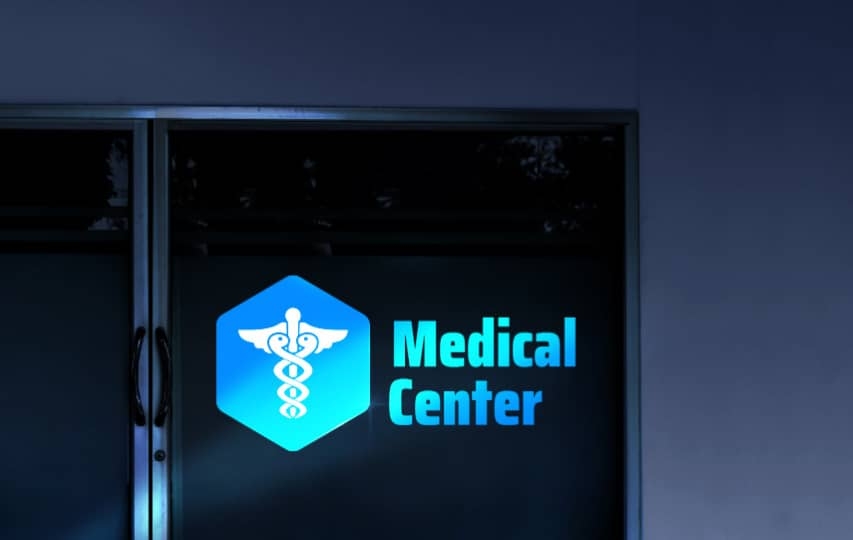 Blue reflective lettering and decals for Medical Center with caduceus symbol.