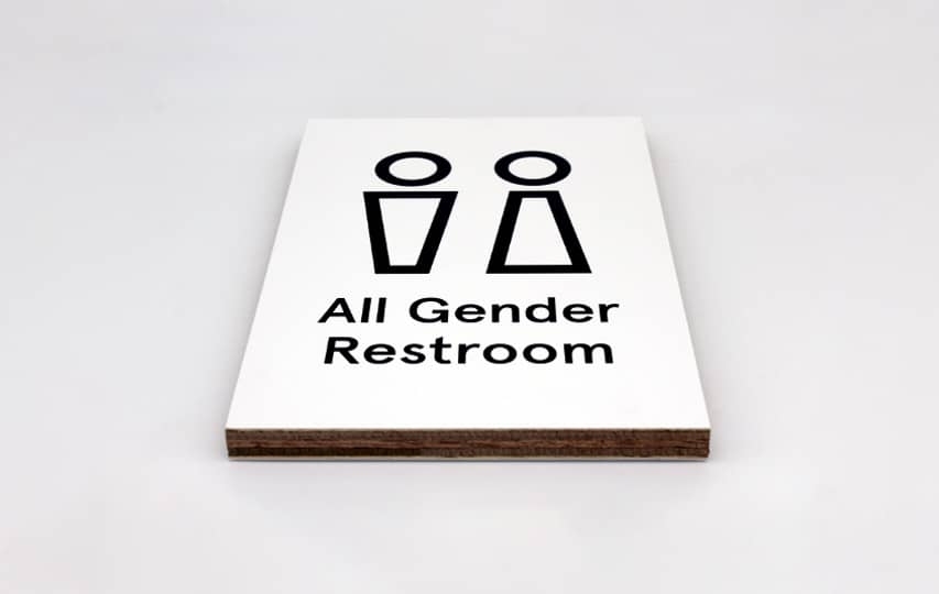 Wayfinding wooden signs for restrooms featuring the men and women icons.