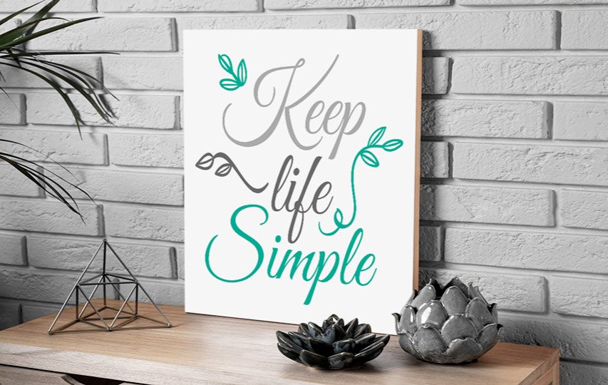Branding wooden sign reading Keep Life Simple with decorative elements.